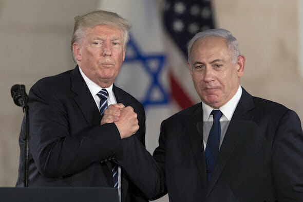 Donald Trump and Benjamin Netanyahu hold hands