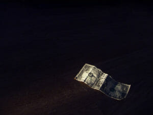 Paper currency floating in dark background