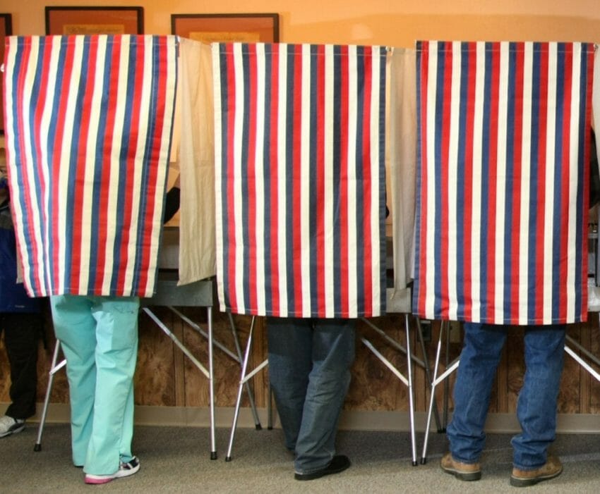 people in a voting booth