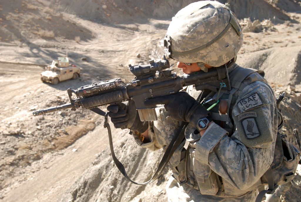 a soldier points a gun