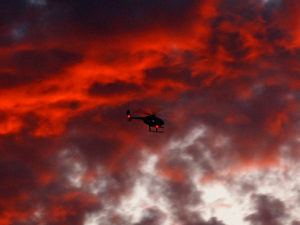 Helicopter flies over a California wild fire.