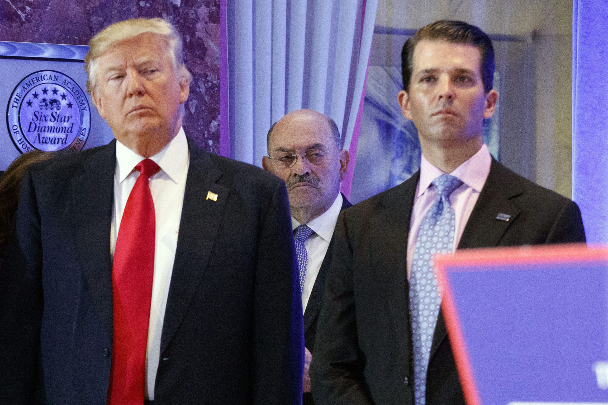 Allen Weisselberg, flanked by Donald Trump and Donald Trump Jr.