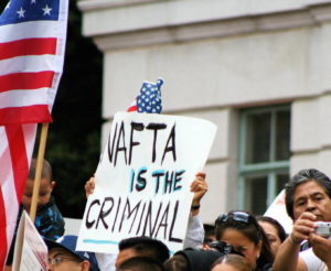 a sign reads 'NAFTA is the criminall'