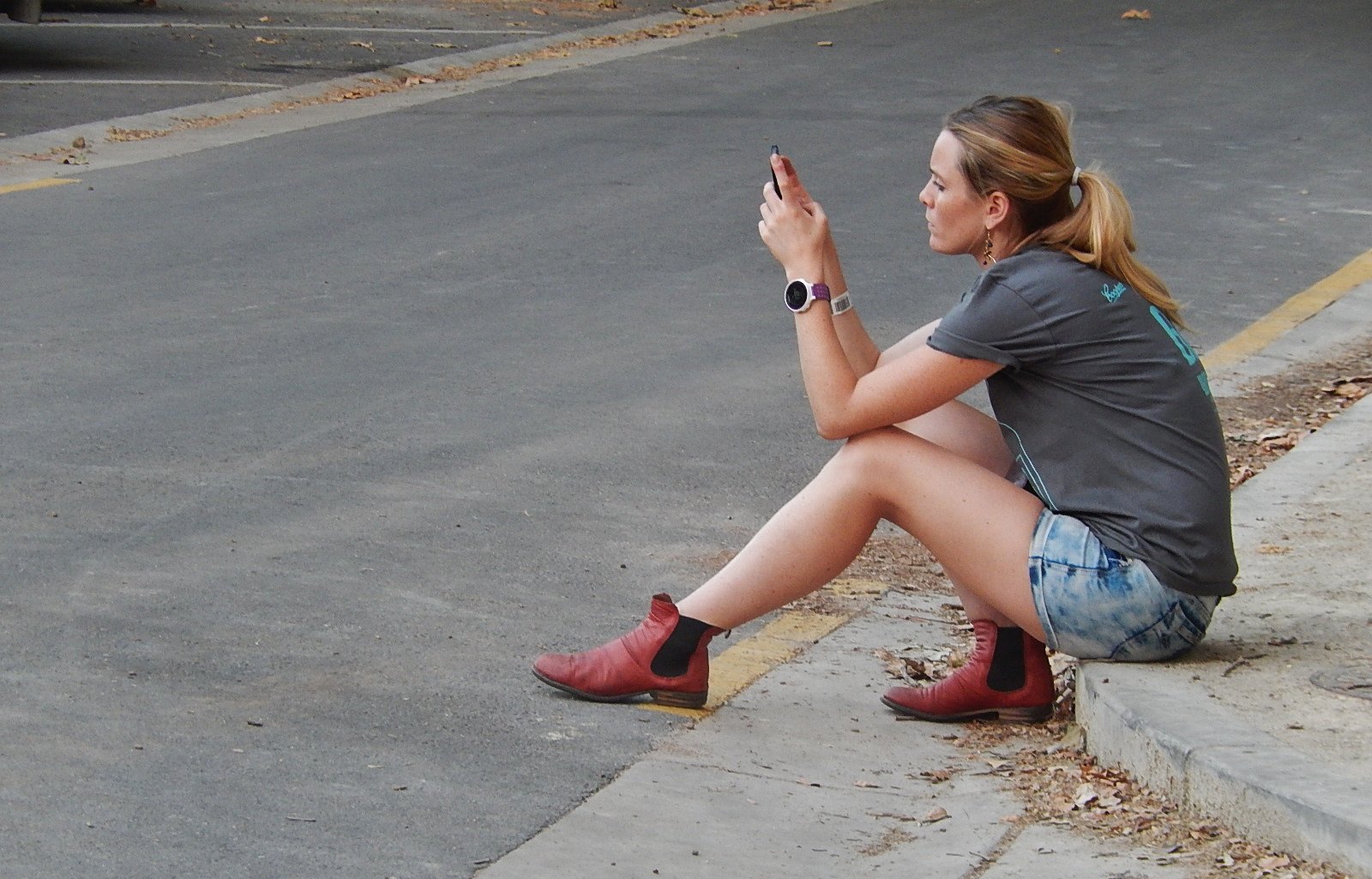 A woman checks her phone.