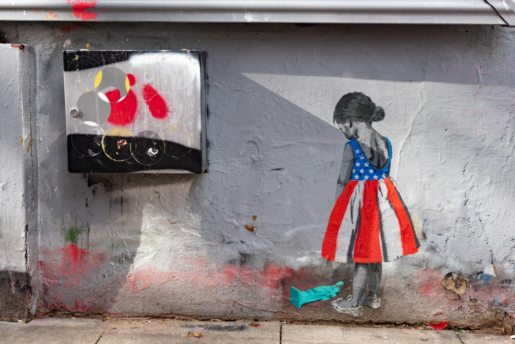 street art of a girl dressed in an American flag dress