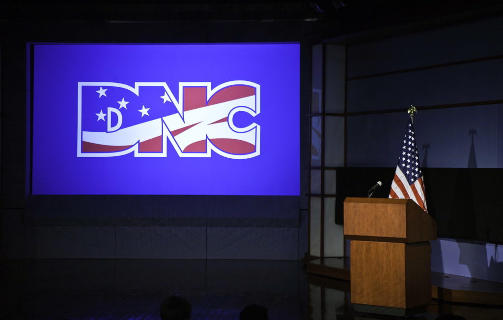 American flag in front of a DNC brand image