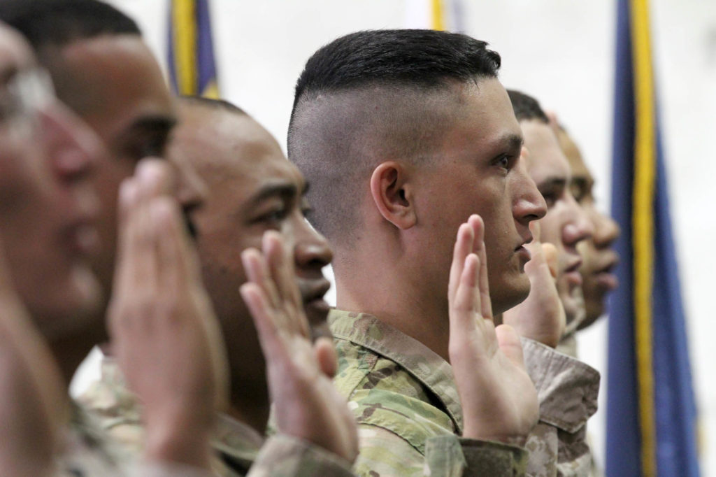 Over 30 American military members recite their oath of allegiance as they are sworn in as naturalized citizens on Nov. 2, 2012, at Bagram Airfield in Afghanistan.