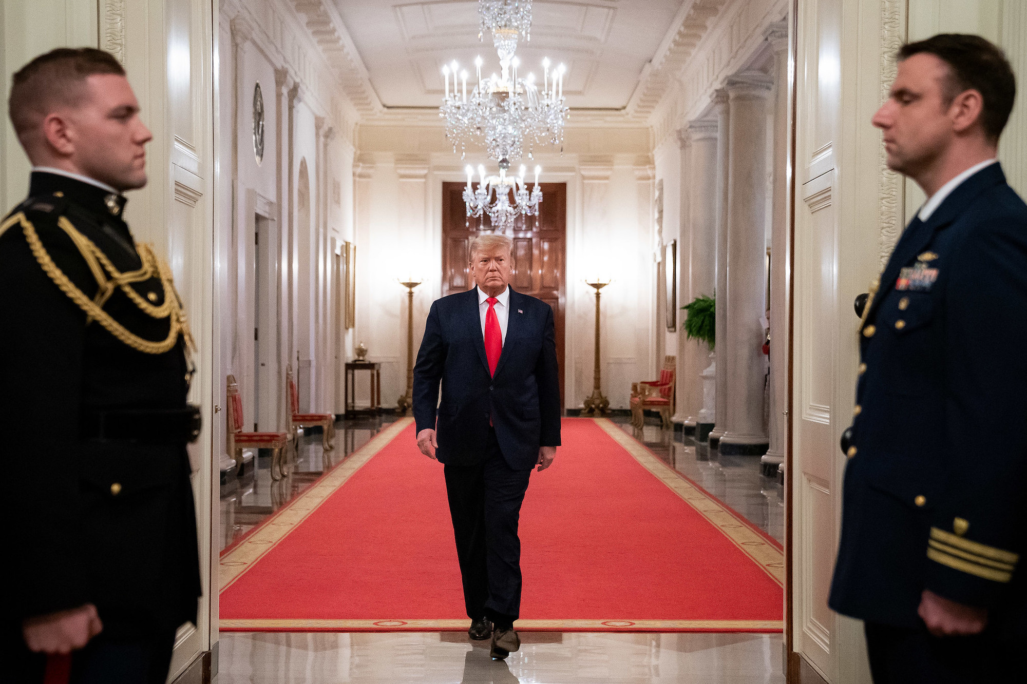 Donald Trump striding down a hallway