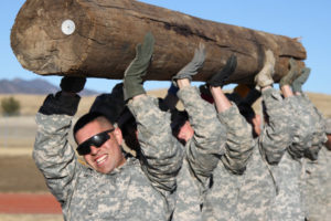 U.S. soldiers lifting a log.