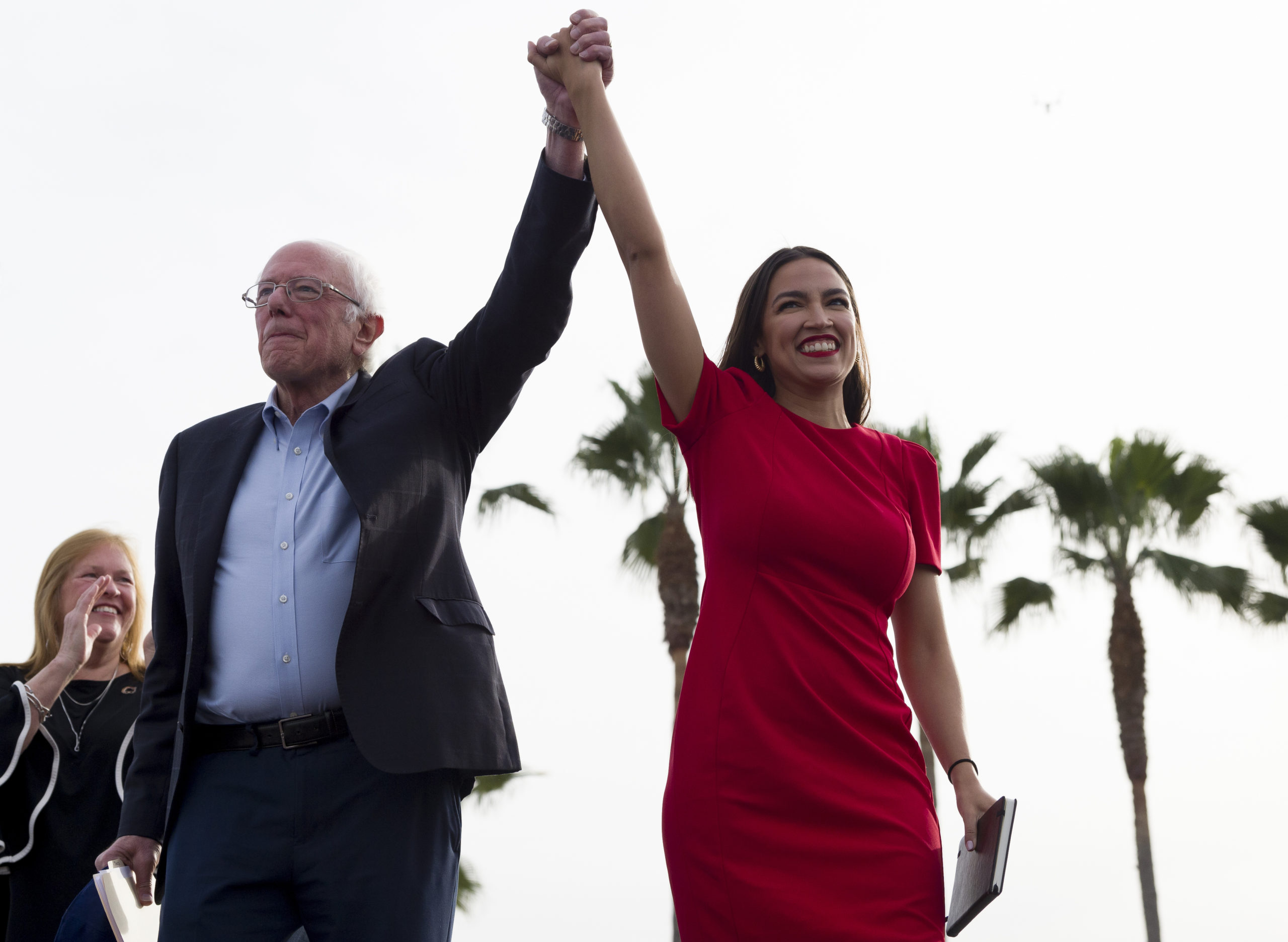 Bernie Sanders and Alexandria Ocasio-Cortez among palm trees.