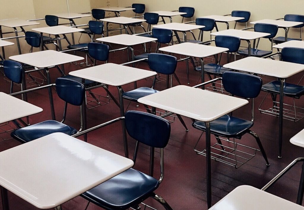Empty desks and chairs in a classroom