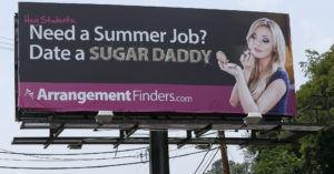 Billboard advertising a "sugar daddy" service