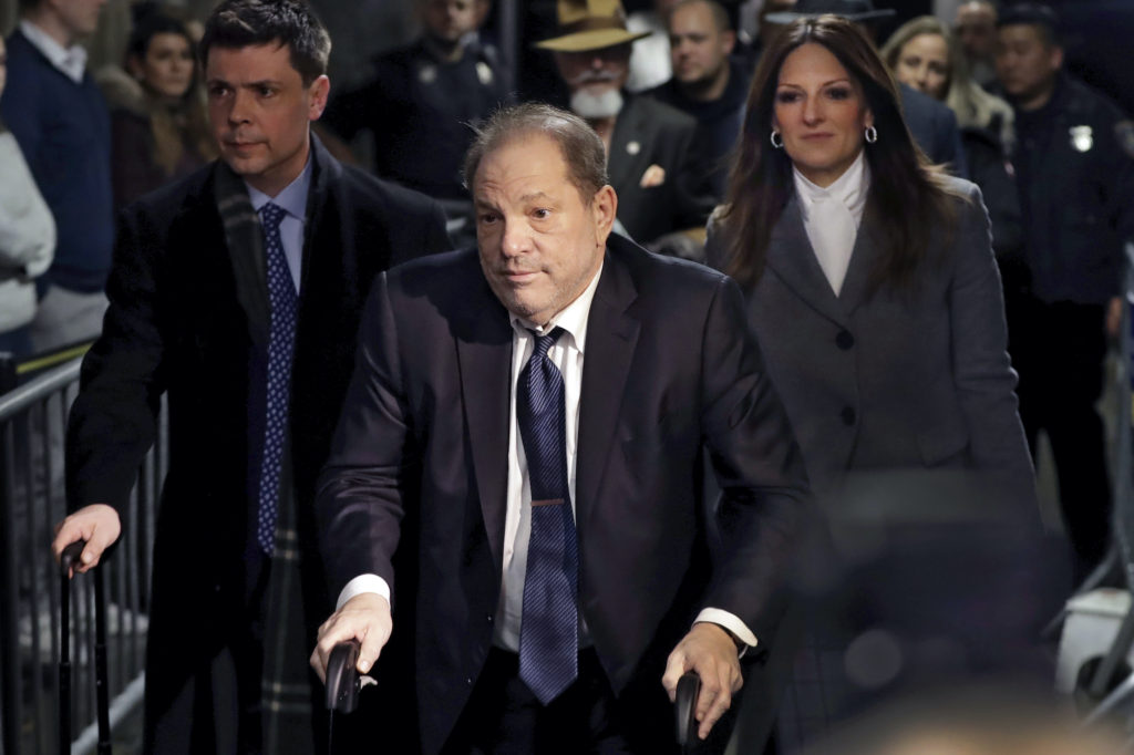 Harvey Weinstein in front of a Manhattan courthouse with his legal team