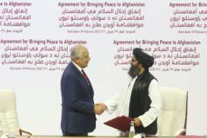 Taliban and U.S. officials shake hands over Afghan peace deal