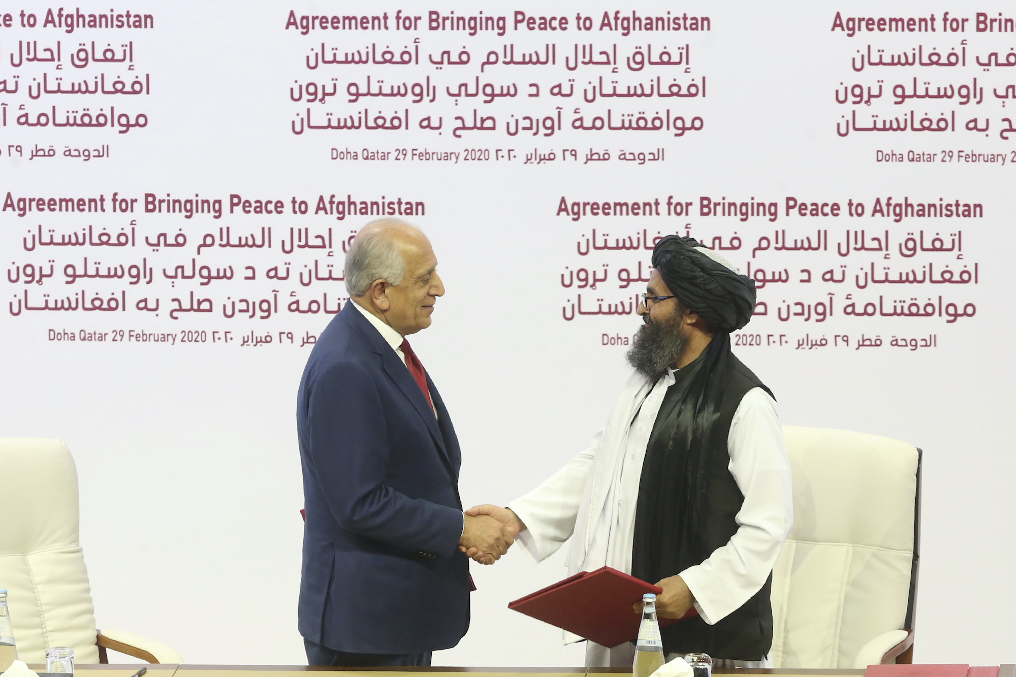 Taliban and U.S. officials shake hands over Afghan peace deal