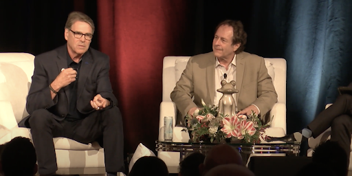 Rick Perry and Rick Doblin, seated, speak before an audience