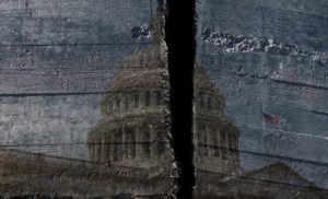 The United States Capitol Building is painted onto a rough wall with a black line down the center, splitting the building in half.