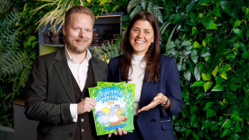 Baseload Capital’s chief marketing officer Kristina Hagström Ilievska, right, the book's author, and CEO Alexander Helling hold "Our Hidden Powers: The Big Switch.”